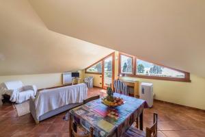 a living room with a table and a couch at Casa Caterina Mansarda vista Lago in Marone