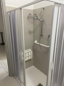 a shower with a glass door in a bathroom at Albahome, Comoda casa vacanze centralissima e panoramica in Agrigento