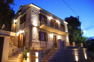 a house with lights on the front of it at Villa Votsalo in Kiónion