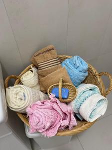 a basket filled with lots of different colored towels at Albahome, Comoda casa vacanze centralissima e panoramica in Agrigento +21 photos