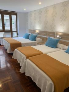 Postel nebo postele na pokoji v ubytování Hostal San Fernando