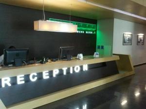 a reception desk with a sign that reads reception at Apartment in Orbi Sea Tower in Batumi