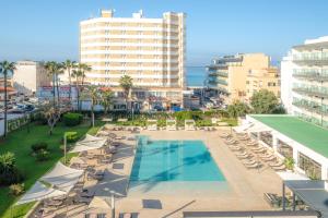 a swimming pool with lounge chairs and a building at Helios Mallorca Hotel & Apartments in Can Pastilla