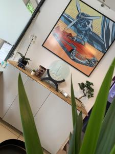 a room with a desk with a picture of a car on the wall at Hotel centre Rouen in Rouen