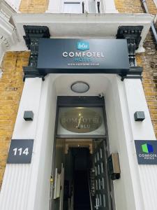 a front door of a building with a sign on it at Comfotel BLU in London