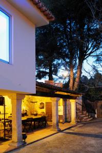 a house with a patio with a table and trees at Slow House y La cabaña de Miss Slower in Nigrán