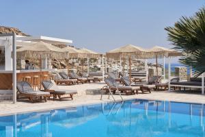 a pool at a resort with chairs and umbrellas at Paradise View Hotel in Paradise Beach