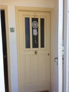 a door in a hallway with a window and a door with a ornament at Vranadika in Livadi