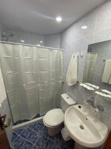 a bathroom with a toilet and a sink and a shower at Palma Beach Hotel in Kranevo