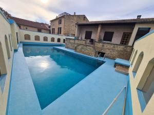 a swimming pool with blue water in a building at Suite parentale Castillon du Gard in Castillon-du-Gard