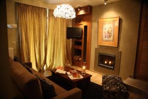 a living room with a couch and a fireplace at Mousiko Pandoxeio in Steni Dirfyos