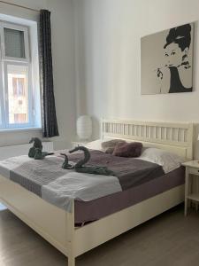 a bedroom with a bed with a stuffed snake on it at Dora apartment near Buda Castle with PARKING! in Budapest