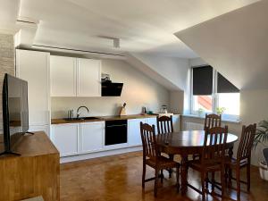 a kitchen with a table and chairs in a room at Apartament Batorego in Skierniewice