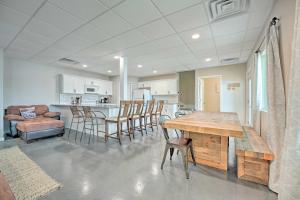 a kitchen and dining room with a wooden table and chairs at Coldwater Family Retreat with Boat Dock and Grill! in Coldwater