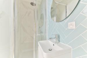 a bathroom with a sink and a shower and a mirror at indépendant flat: canal st martin&trains stations! in Paris +9 photos