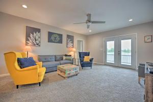 a living room with a couch and two chairs at Coldwater Family Retreat with Boat Dock and Grill! in Coldwater
