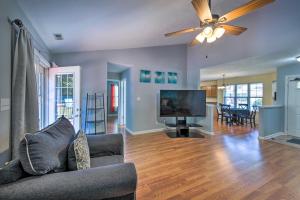 a living room with a couch and a flat screen tv at Family Home Near Indianapolis Speedway and Dtwn in Indianapolis