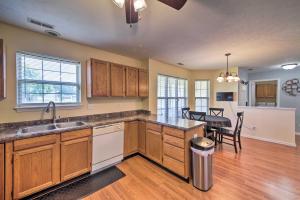 a kitchen with wooden cabinets and a dining room at Family Home Near Indianapolis Speedway and Dtwn in Indianapolis