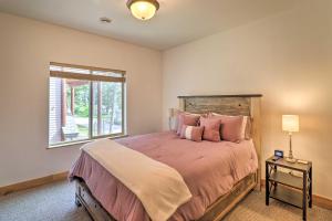 a bedroom with a large bed and a window at Flathead Lake Getaway with Balcony, Fireplace! in Somers