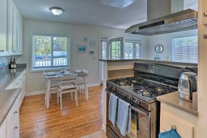 a kitchen with a stove and a table at Orange County Gem Walk to Crescent Bay Beach in Laguna Beach