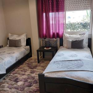 Кровать или кровати в номере Appartement au cœur du centre ville de Rabat