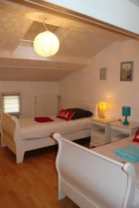 een slaapkamer met 2 bedden en een bank bij Maison de 3 chambres avec jardin clos et wifi a Vasles in Vasles