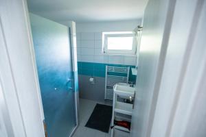 a small bathroom with a sink and a window at Apartmány Na Obci Třeboň in Třeboň +53 photos