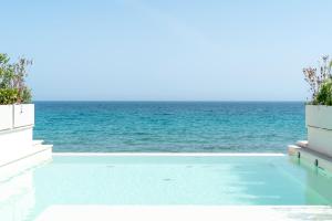 a swimming pool with the ocean in the background at New Bussola in Quartu SantʼElena