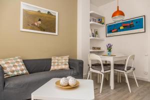 a living room with a couch and a table at Opening Doors Gràcia in Barcelona