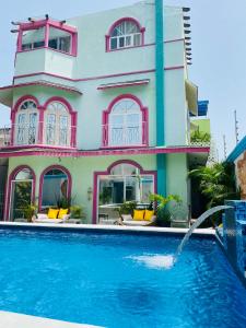 a house with a swimming pool in front of a house at The Quetzal in Cancún