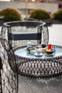 a table with a tray of food on a wicker chair at Veranda Hotel Vina del Mar in Viña del Mar
