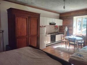a room with a kitchen with a table and a kitchen at River and Mounts in Campertogno