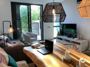 a living room with a table with a laptop on it at Ponent Formentera in La Savina