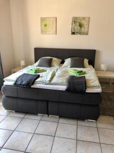 a bed with a black frame in a bedroom at Ferienwohnung Lutz in Ascheberg