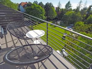 a balcony with a bench and a view of a park at Willa Liliowa in Dębki +32 photos