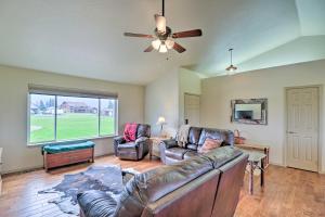 a living room with two couches and a ceiling fan at Columbia Falls Home with 1-Acre Yard and Views! in Columbia Falls