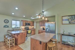a kitchen with wooden cabinets and stainless steel appliances at Columbia Falls Home with 1-Acre Yard and Views! in Columbia Falls