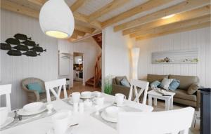 a living room with a white table and chairs at Amazing Home In Ostseeresort Olpenitz With Sauna in Olpenitz