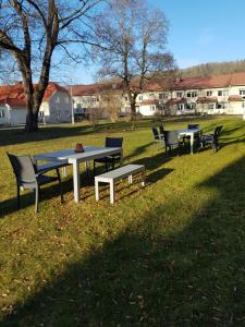 a picnic table and benches in a park at Huskvarna Hotell & Vandrarhem in Huskvarna