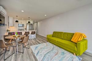 a living room with a green couch and a table at Chic Condo with Shared Hot Tub on Mission Bay! in San Diego
