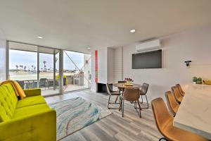 a living room with a yellow couch and a table at Chic Condo with Shared Hot Tub on Mission Bay! in San Diego