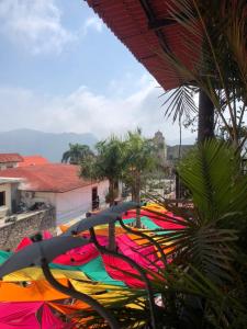 a group of colorful umbrellas sitting on a balcony at Grann Posada Xilitla in Xilitla