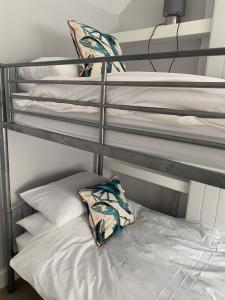 a bunk bed with two pillows on top at Perfect base for 8 in Tenby