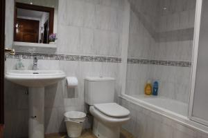 Un baño con inodoro, lavabo y bañera. en Casa Esmeralda by CasaTuristica, en Ronda