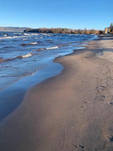 an empty beach with water and sand and acean at Huskvarna Hotell & Vandrarhem in Huskvarna