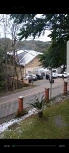 a street with cars parked in a parking lot at Hospedagem Vó Lina in Gramado