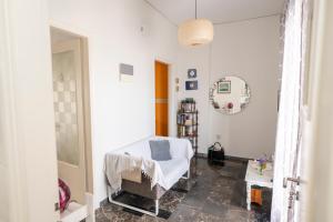 ein weißes Zimmer mit einem Bett und einem Spiegel in der Unterkunft MK Apartment in Lávrio