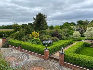 a garden with a table in the middle of it at Beautiful 3 Bedroom Cottage - Picturesque Retreat in Lichfield