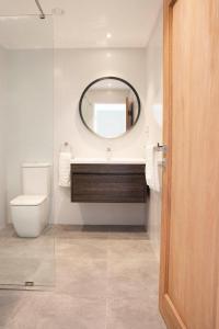a bathroom with a toilet and a mirror at Paradise Heights Luxury Apartments & Villa in Beau Vallon +17 photos