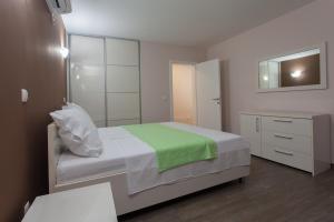 Postel nebo postele na pokoji v ubytování Buna Spring Apartments
